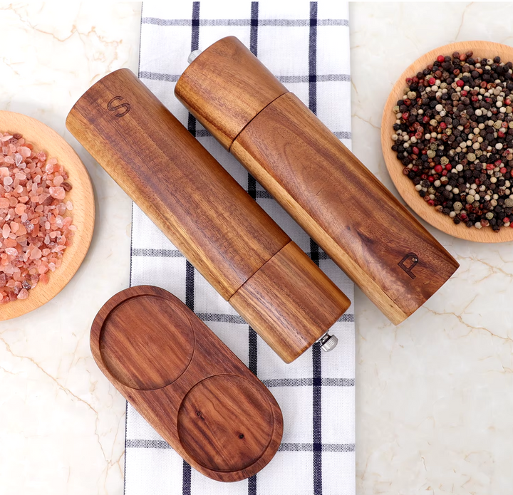Large display of natural teak wood kitchen utensils, showcasing a comprehensive cooking tool set.