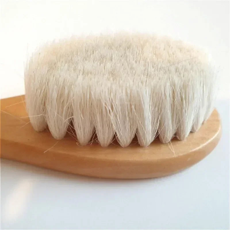 Close-up of baby brush with smooth wooden handle and fine wool bristles for delicate hair