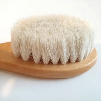 Close-up of baby brush with smooth wooden handle and fine wool bristles for delicate hair