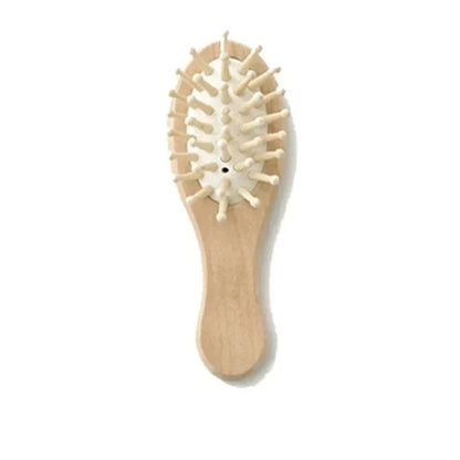 Soft-bristled baby comb with a polished wooden design, promoting healthy infant hair growth