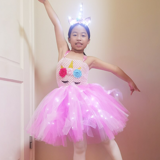 Girl in glowing LED Unicorn Tulle Party Dress, sleeveless, rainbow skirt, perfect for birthdays