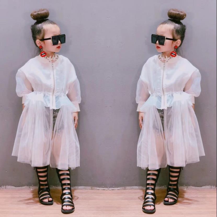 Stylish young girl in a vibrant mesh coat, excellent for spring or fall outerwear.