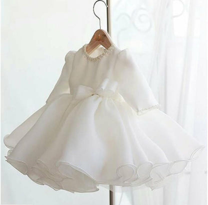 Toddler girl in a white princess ball gown with pearl neckline for a special occasion or flower girl role.