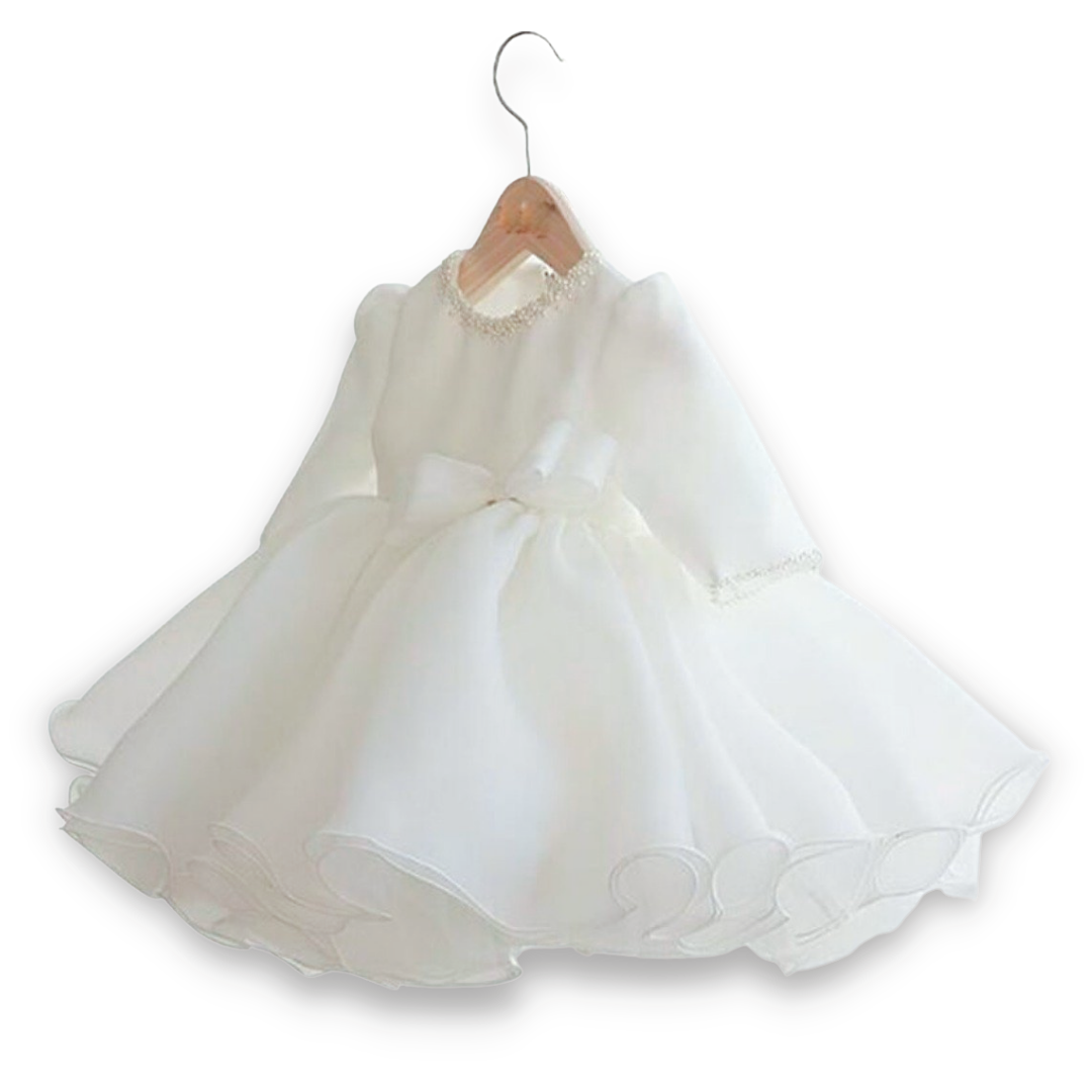 Full view of a girl's delicate bridal white baptism or wedding ball gown with intricate pearl details on the neck.