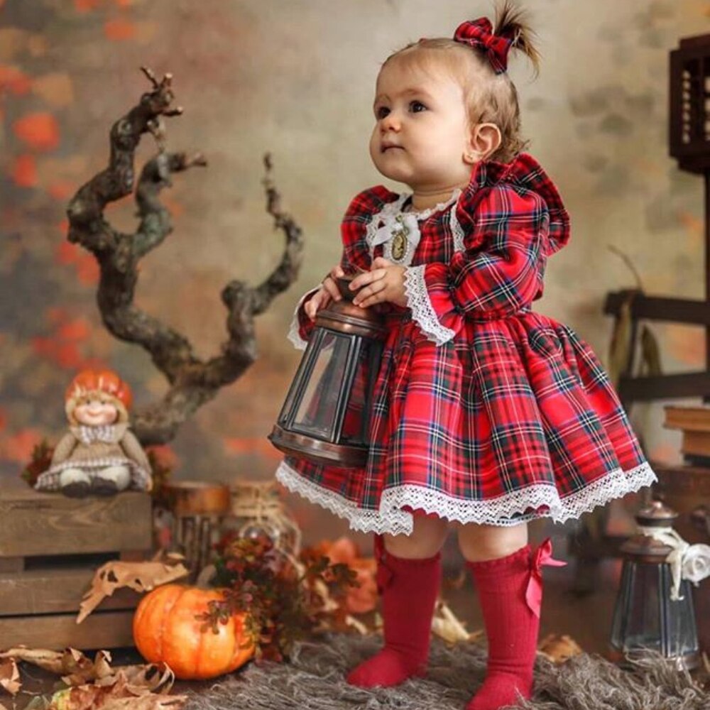 Girl's red plaid romper with ruffle detail, perfect for baby holiday wear or Christmas outfit.