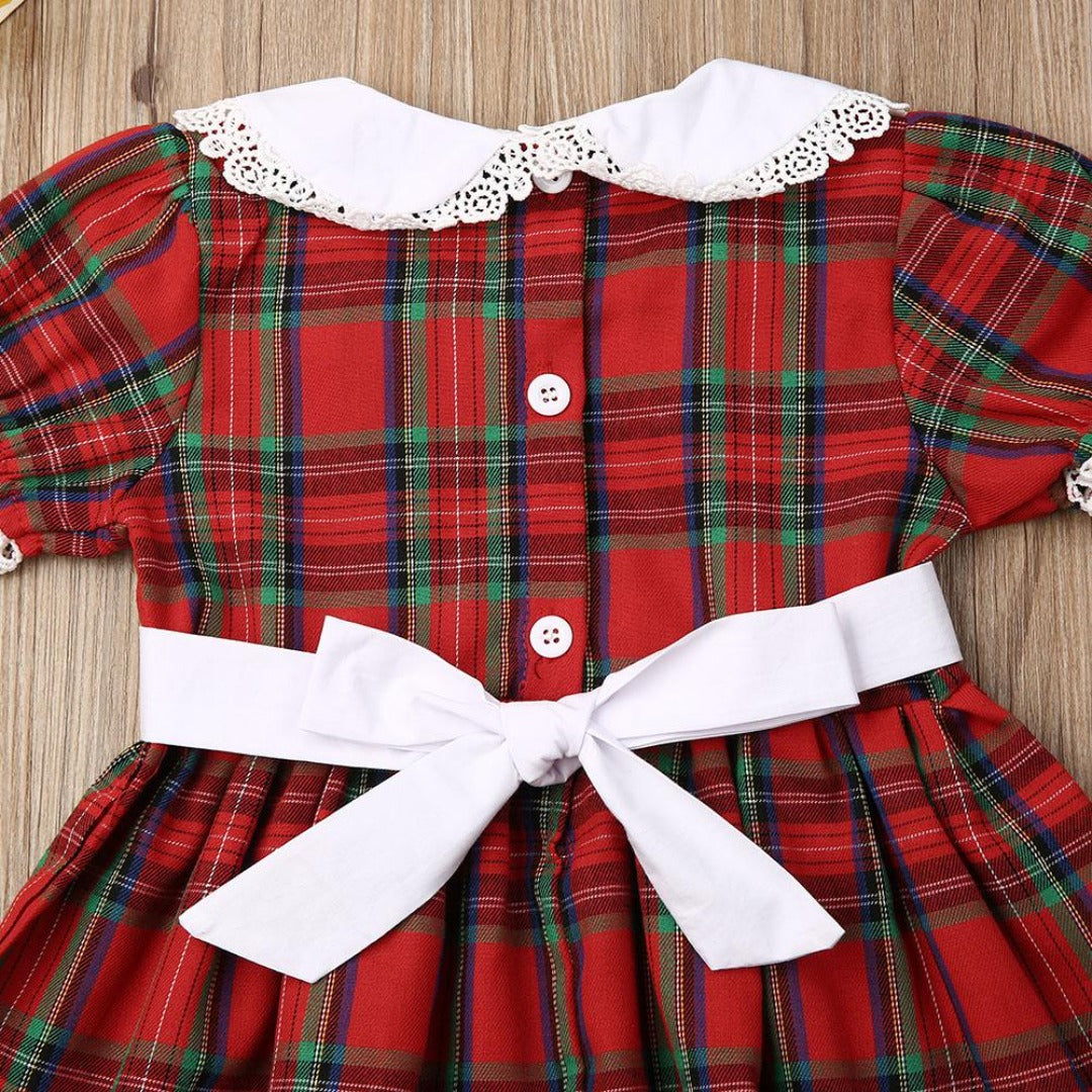 Infant girl's red plaid romper with smocking detail, a cute and festive baby clothing option.
