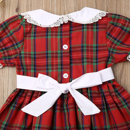 Infant girl's red plaid romper with smocking detail, a cute and festive baby clothing option.