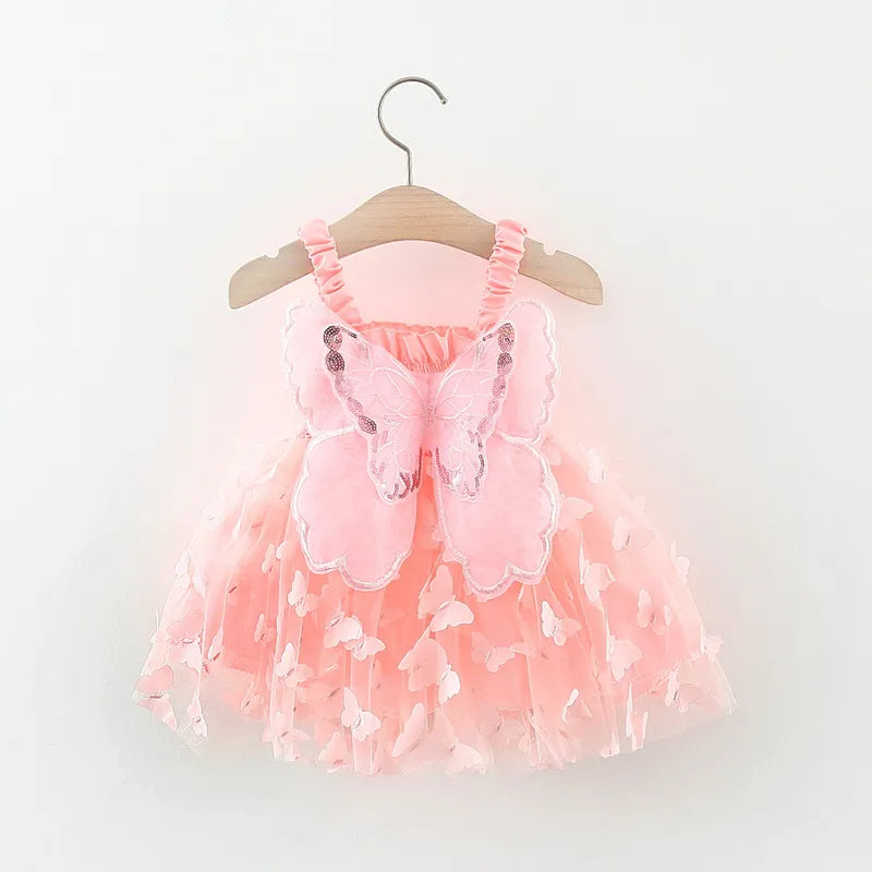 Close-up of the intricate 3D butterfly details on a girls' pink princess summer dress