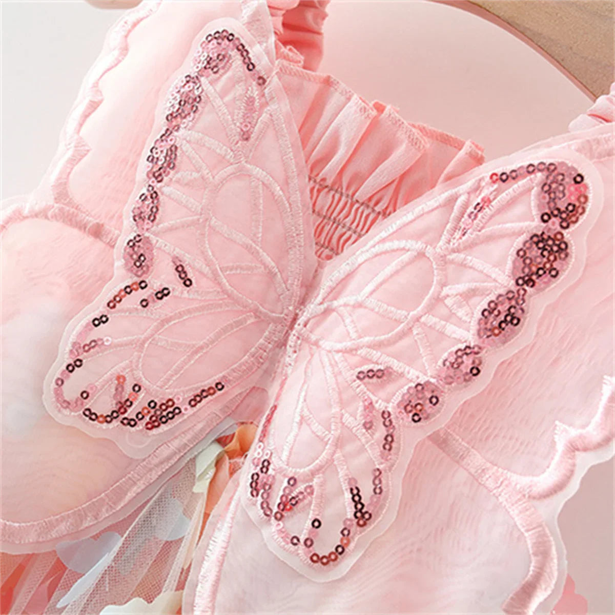 Back view of a lovely girls' sleeveless 3D butterfly princess summer dress for kids