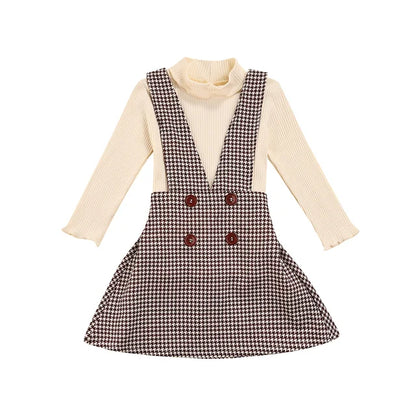 Kids' fall clothing: a fashionable turtleneck and plaid pinafore skirt set, perfect for autumn