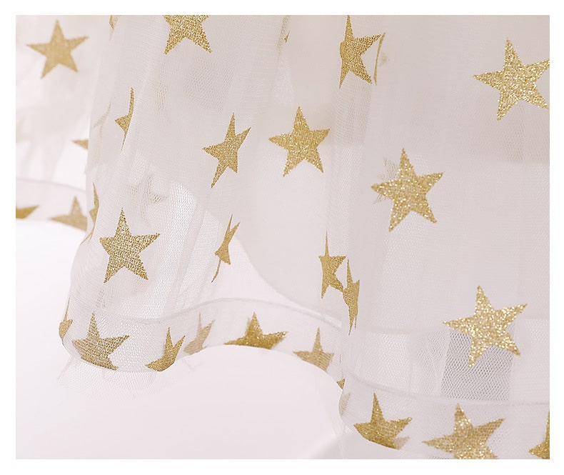 Close-up of shimmery sequins & star details on a girls' backless princess dress, ideal for parties.