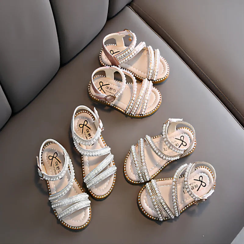 Close-up of girls' bling sandals, showing sparkling rhinestones and floral details