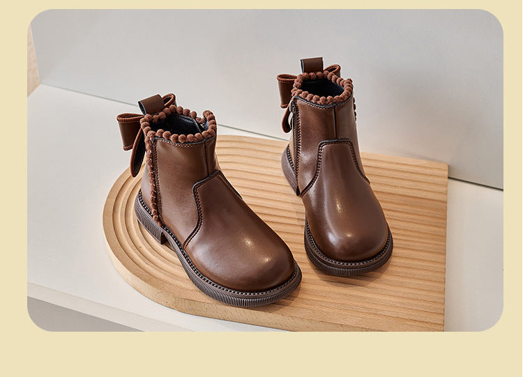Pair of black girls' faux leather ankle boots with zippers, a stylish and practical footwear choice.