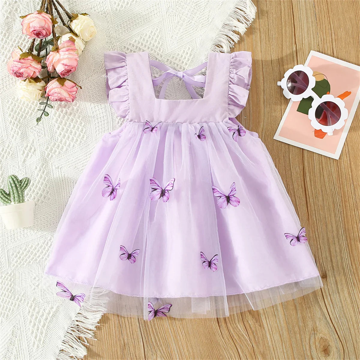 Kids clothing: pretty pink butterfly mesh summer dress with bow detail