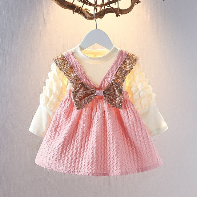 Detailed shot of the candy stripes fabric on a girls' summer dress and headband