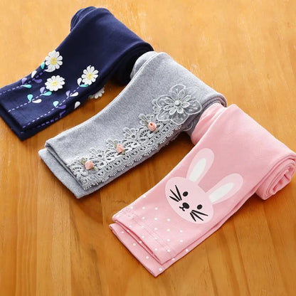 Elastic waist girls' leggings with whimsical cartoon prints, ideal for active play.