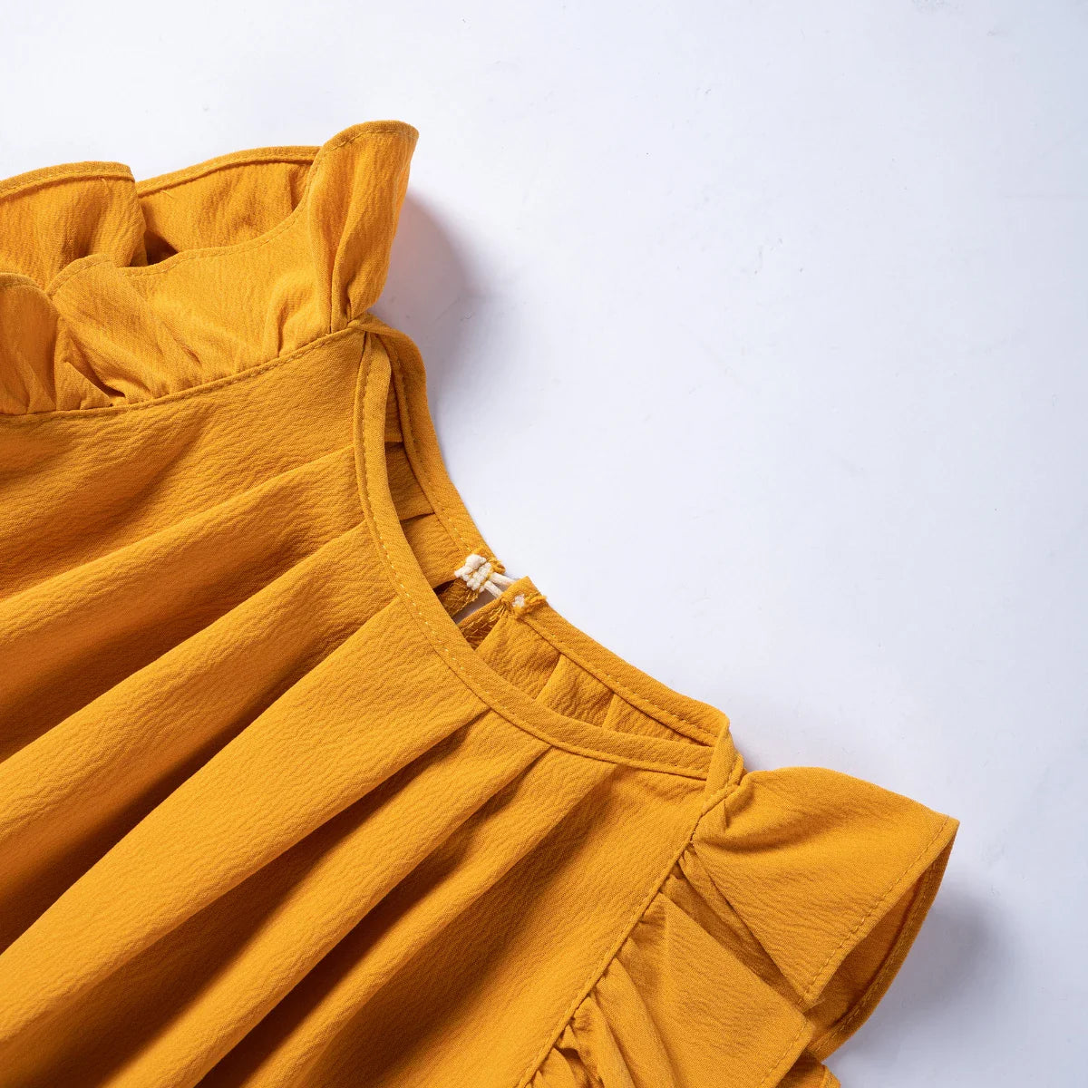 Sweet flying sleeves on a vibrant pink girls' casual summer dress, close-up view