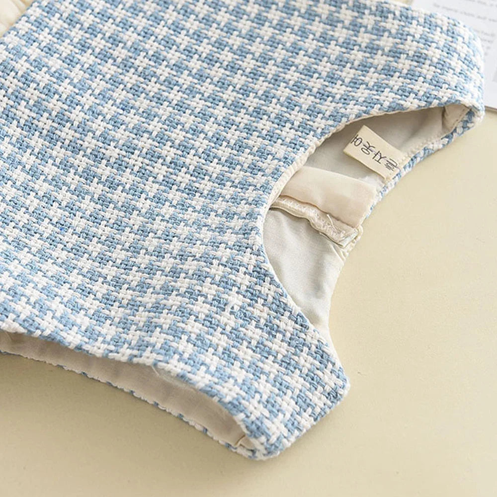 Stylish kids' clothing: retro-inspired coat paired with a classic checkered dress