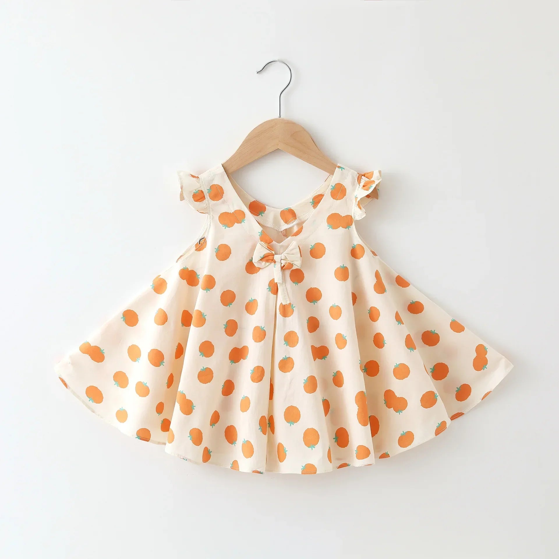 Toddler girl in a white cotton floral summer dress, an A-line style for kids fashion.