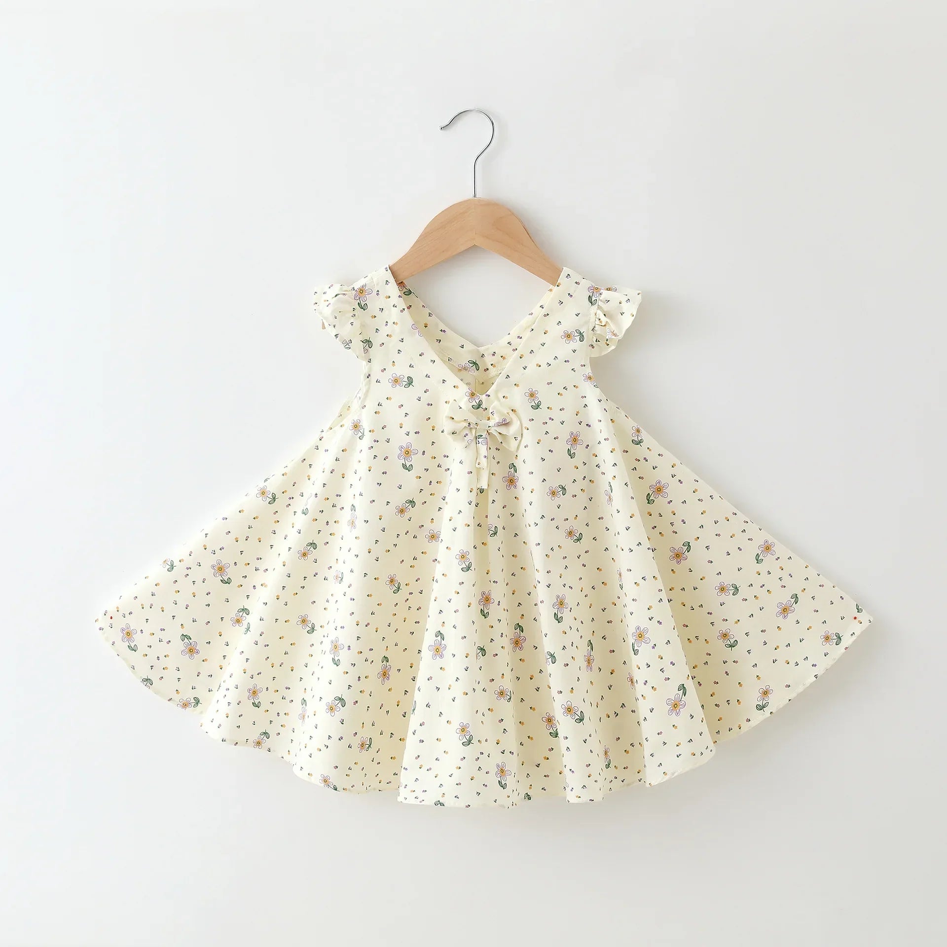 Side view of a comfortable girls' A-line cotton summer dress with bright floral details.
