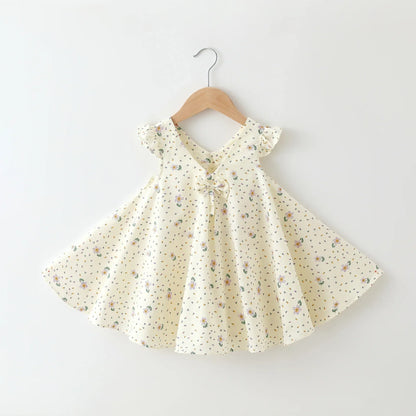 Side view of a comfortable girls' A-line cotton summer dress with bright floral details.