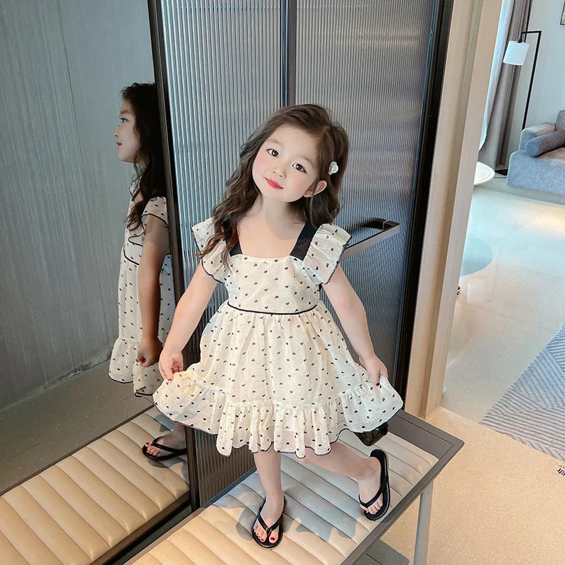 Close-up of a vibrant heart pattern on a cute girls' summer dress, perfect for kids fashion