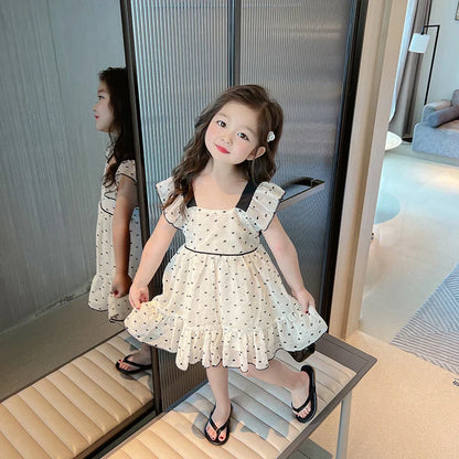 Close-up of a vibrant heart pattern on a cute girls' summer dress, perfect for kids fashion