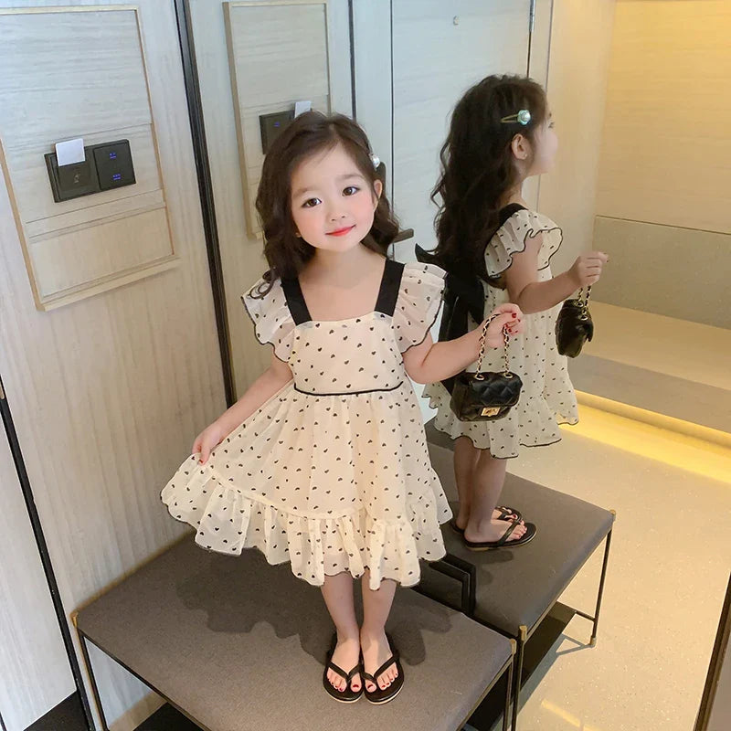 Soft cotton girls' dress featuring an all-over heart pattern, suitable for youth fashion