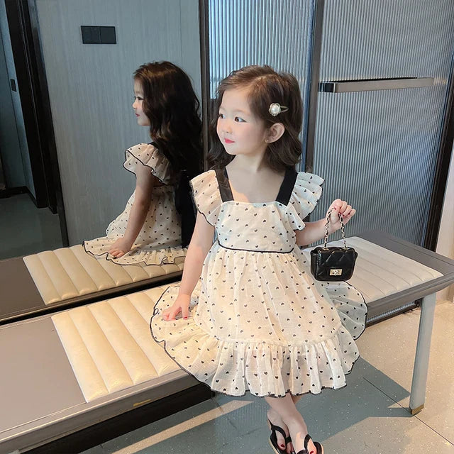 Girls' summer dress with a playful heart print, a must-have for casual kids fashion