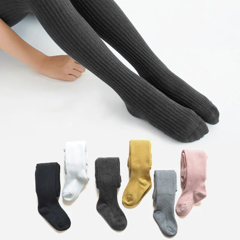 Girls' cozy cotton knitted tights in a soft, solid color, perfect for autumn wear. Soft leggings for kids.