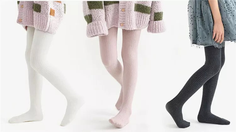 Girls' cozy white cotton knitted tights, perfect for layering and creating comfortable elegant outfits.