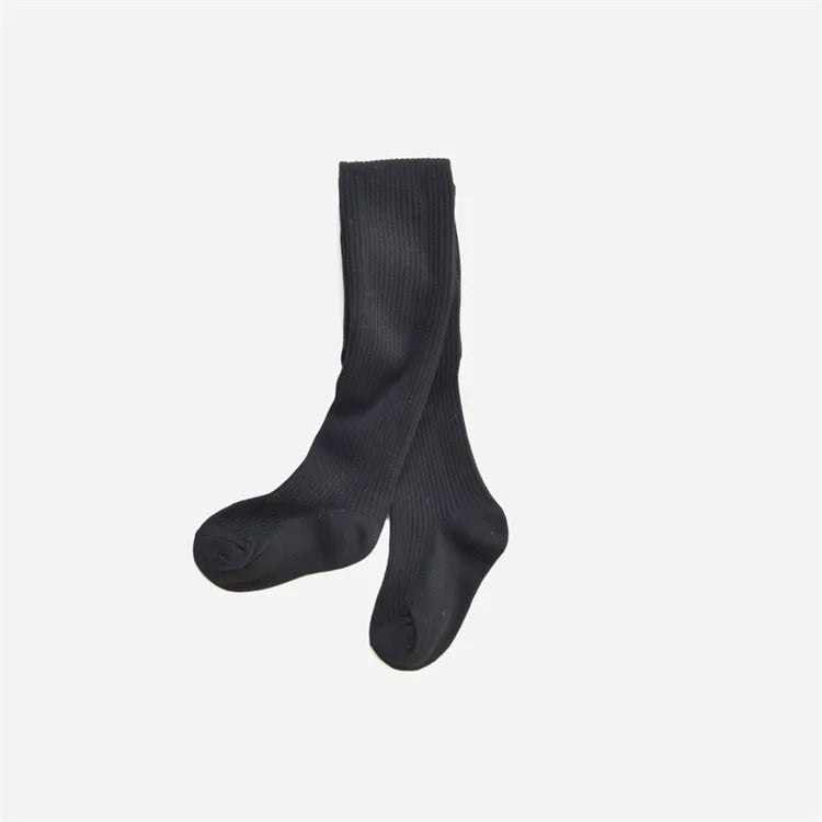 Girls' comfortable black cotton knitted tights, offering warmth and versatility for various outfits.