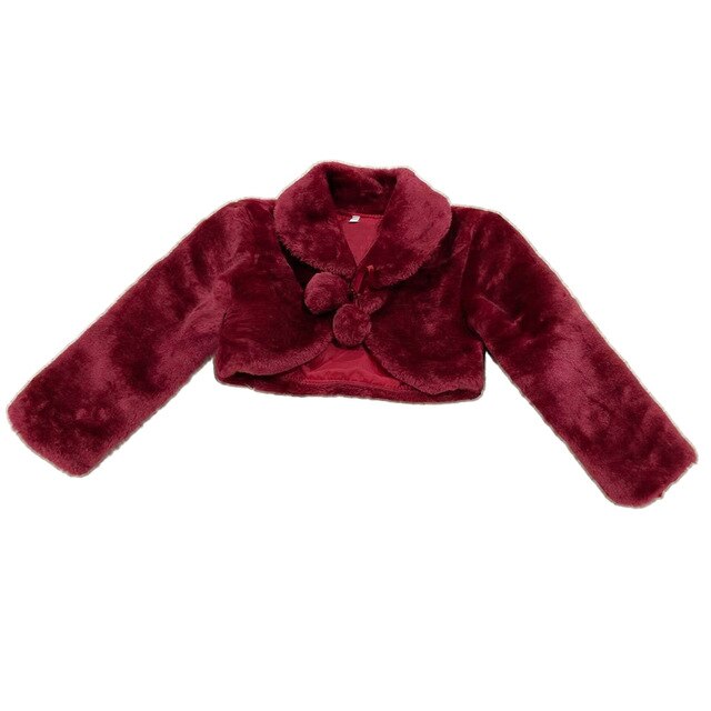Close-up of a girl's fleece bolero jacket showing soft texture and charming pompom button.