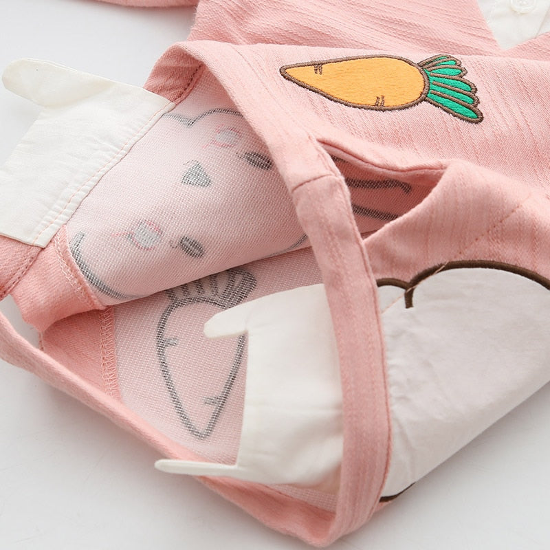 Close-up of a charming carrot rabbit patchwork on a long-sleeve girls' cotton blend sweater, children's apparel