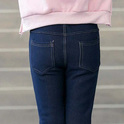 Cozy girls' winter denim pants, warm leggings with elastic waist, ideal for stylish kids' fall playwear.