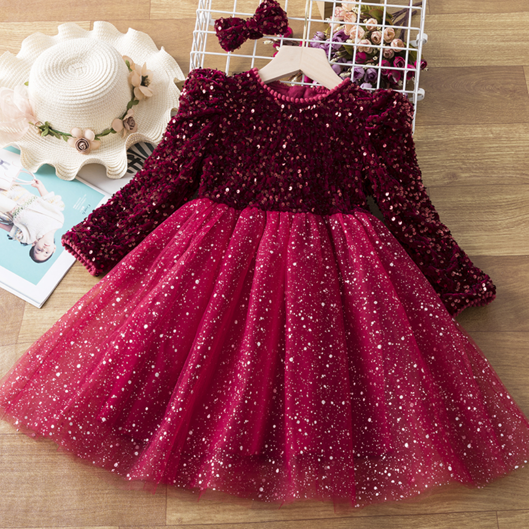 Toddler girl modeling a glittering purple sequin long sleeve princess dress, ideal for holiday events.