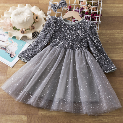 Close-up of a girl's sequin bodice on a long sleeve princess party dress, showcasing intricate detail.