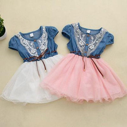 Cotton girls' party dress with a denim bodice, flowing tulle skirt, and beautiful chest embroidery, above knee length.