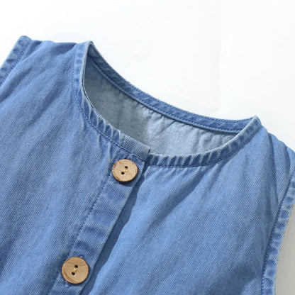 Close-up of embroidered unicorn on a girls' sleeveless denim dress, showcasing intricate detail.