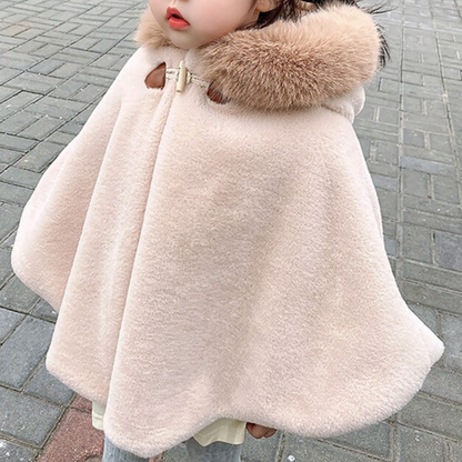 Cute baby girl in a cozy faux fur hooded short cloak, perfect for holiday outfits