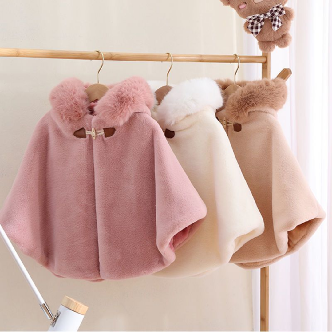 Close-up of a girls' faux fur hooded short cloak, soft texture, ideal for cool weather