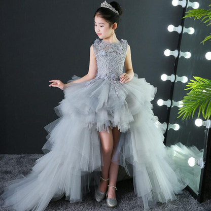 Back view of a girls' formal pink tulle gown featuring intricate lace appliques and a detachable skirt