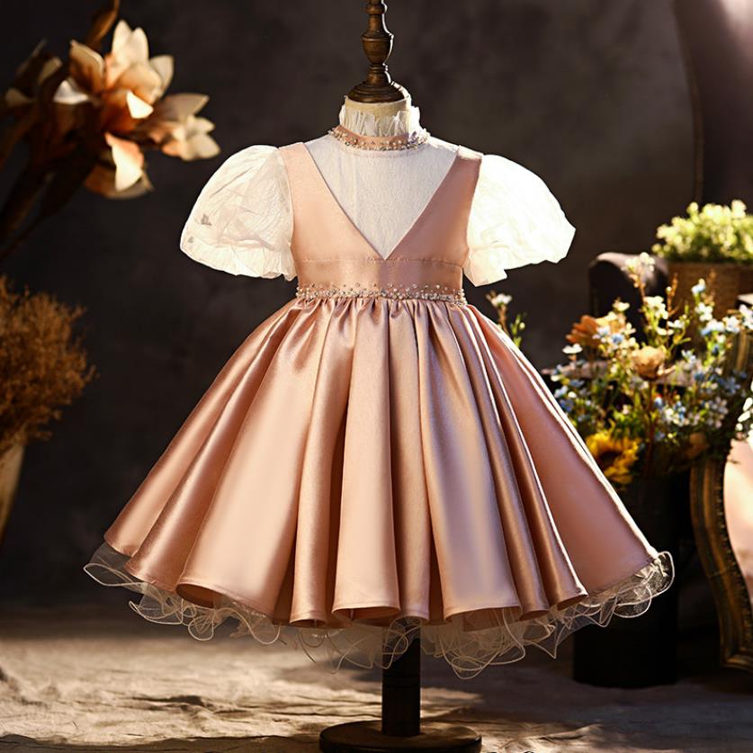 Back view of a stunning girls' white lace floral princess ball gown dress with a large bow