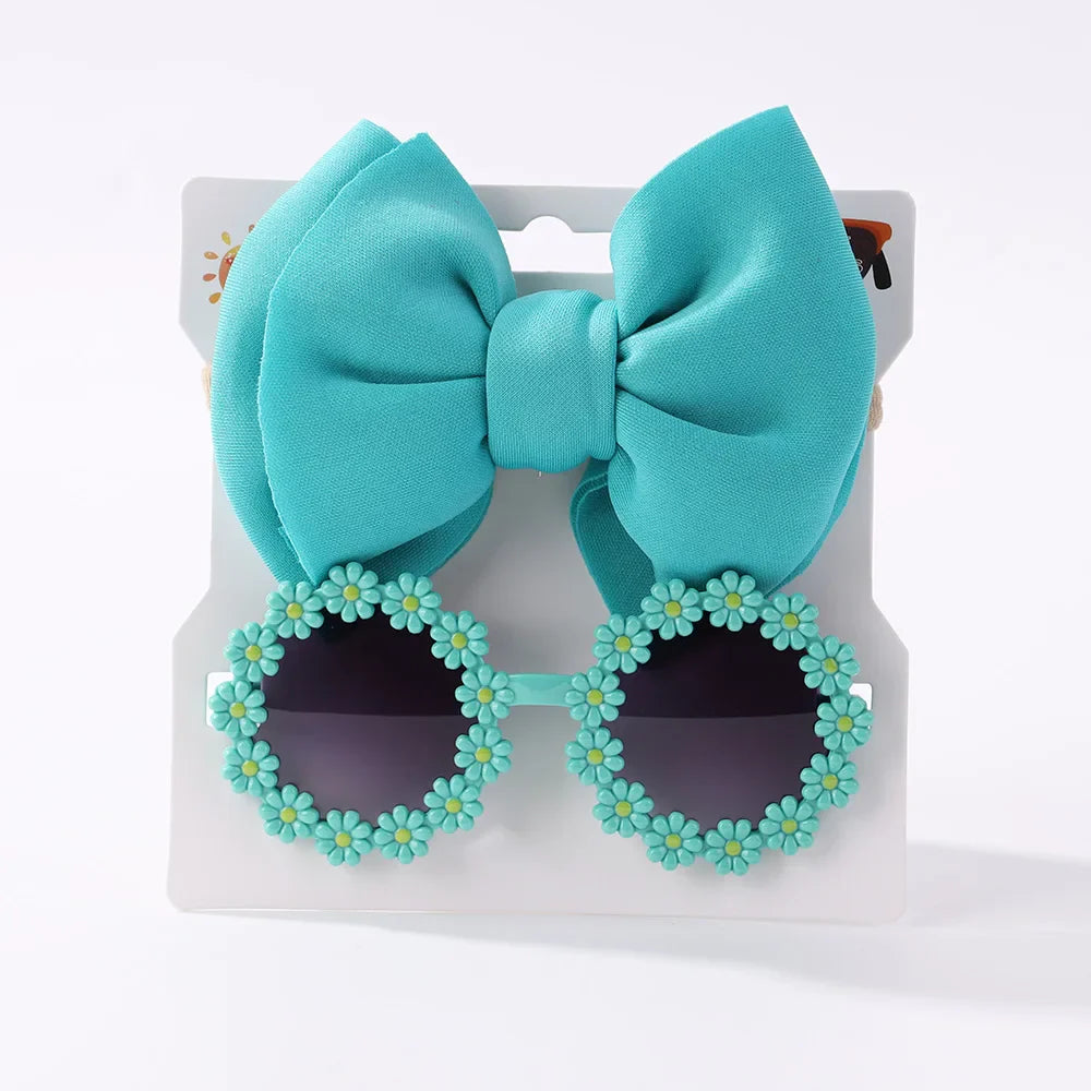 Girls' pink sunglasses in a fun shape paired with a polka dot bow headband for kids