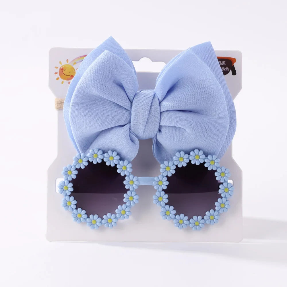 Durable girls' sunglasses offering UV protection, packaged with a charming bow headband