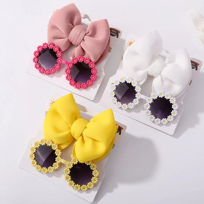 Pink girls' sunglasses with matching bow headband, essential children's summer style accessory