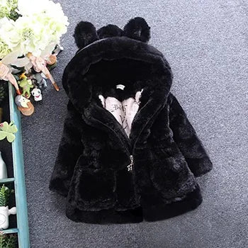 White faux fur winter princess jacket hanging on a hanger, ready for chilly days, kids fashion