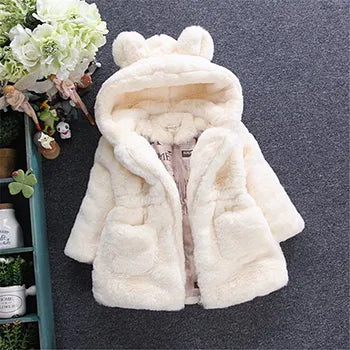 Close-up of the smooth inner lining of a girls' white faux fur winter princess jacket, quality kids coat