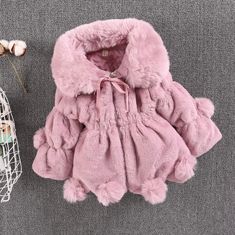 Young girl twirling in her white faux fur winter princess jacket, happy, warm, and cute