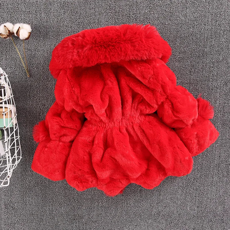 Detail of the faux fur trim on the hood of a girls' white winter princess jacket, warm baby clothing
